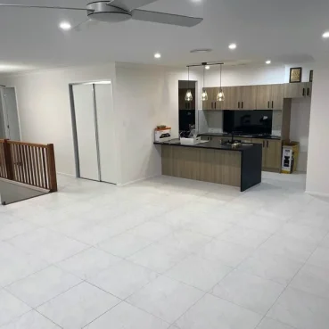 Professionally cleaned open-concept home featuring streak-free marble tiling and a spotless modern kitchen.